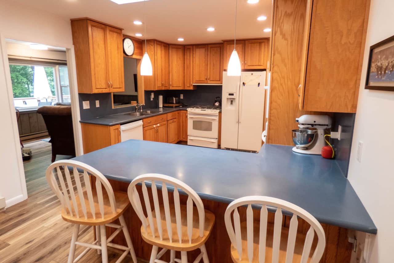 Large kitchen with skylights and bar seating