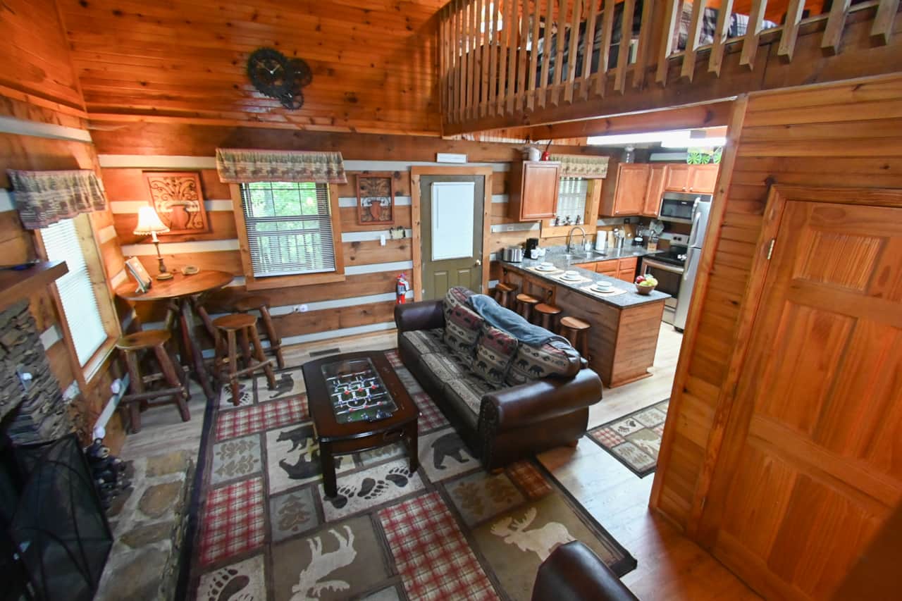 The two-story great room, filled with natural light and log cabin character.