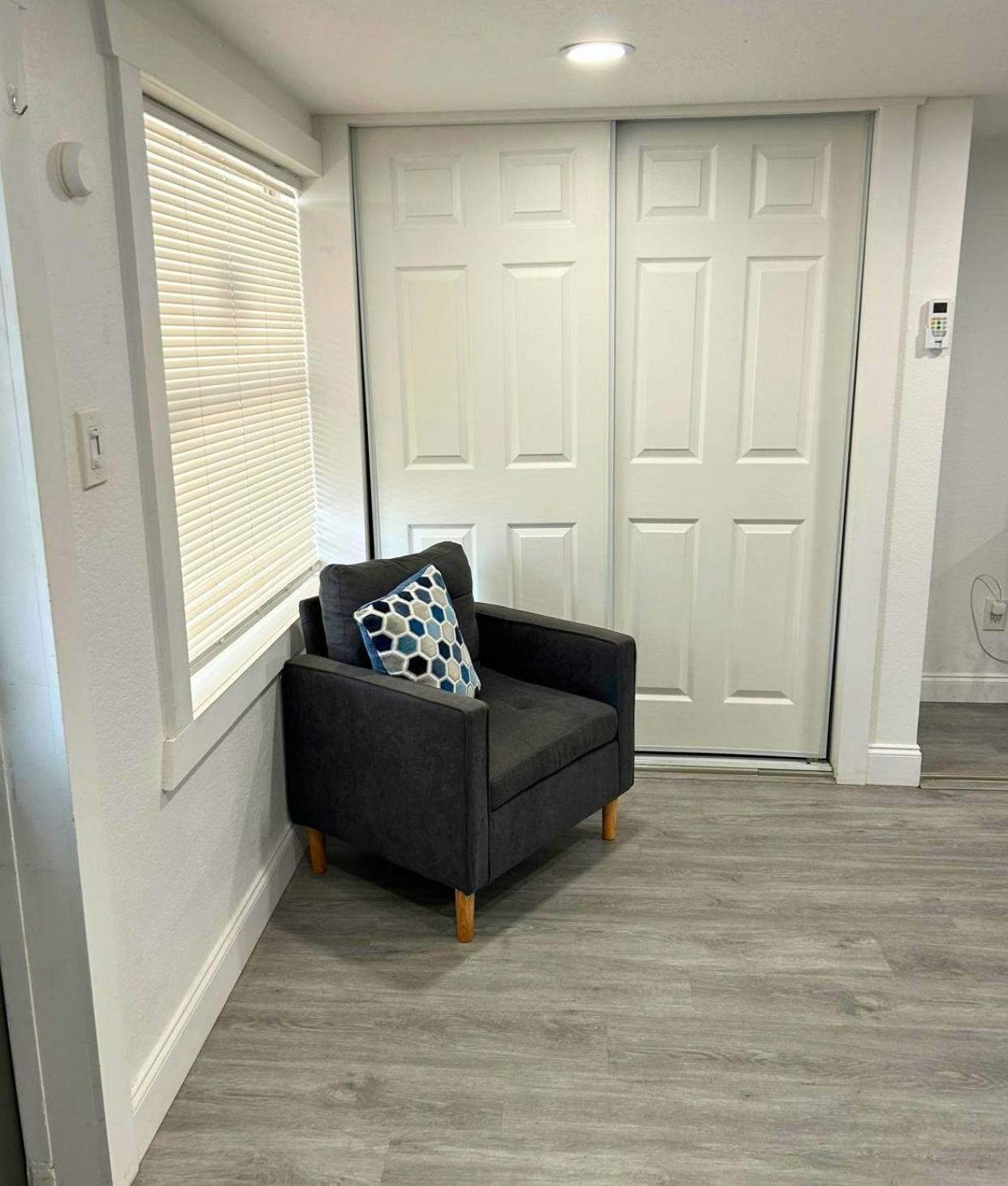 Relax in a cozy accent chair by a large window with beautiful blinds. Lakeland, FL