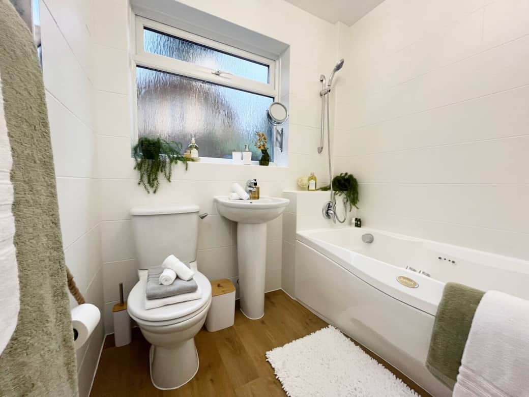 Inviting Family Bathroom: This bright and airy family bathroom offers a relaxing bath, modern fixtures, and a serene atmosphere. The perfect space for a refreshing start to your day or a calming soak in the evening.