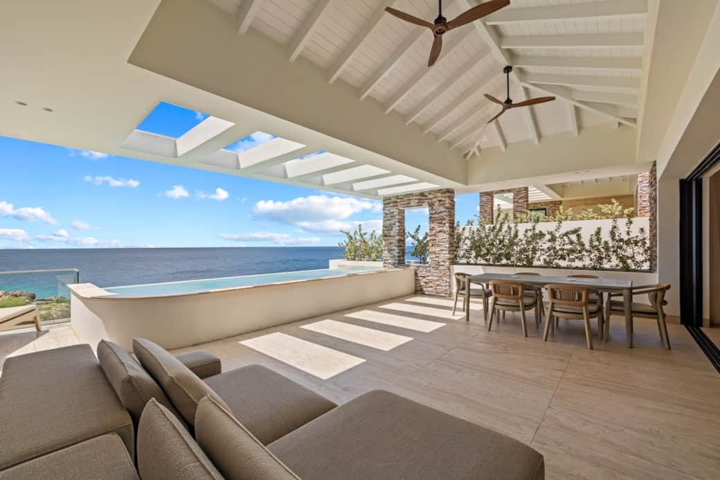 Spacious terrace with dining table, seating area and sun loungers