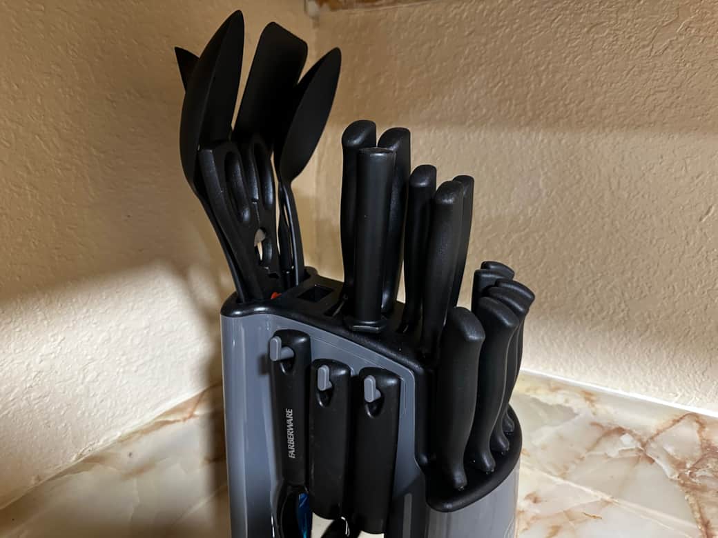knives, spoons, measuring cups can opener and a potato peeler