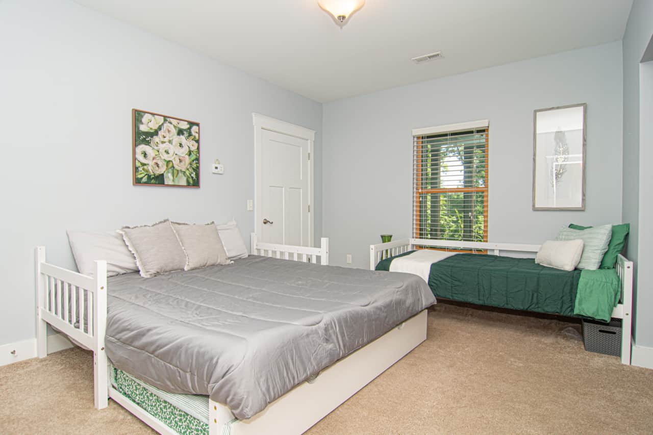 Main Sleeping area with a King bed, separate Twin bed, and Twin Trundle Bed Under the King