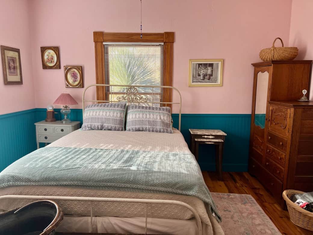 The master bedroom features a queen sized bed, along with a charging device and Alexa for music/alarm.  We also have an airbed stored in a basket behind the door for emergencies. 