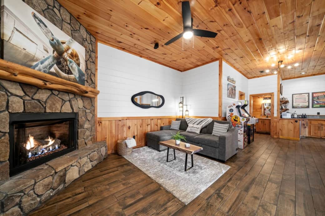 This open-concept game room lets everyone join the fun—play Pac-Man, Golden Tee, pool, darts, or shuffleboard, or relax and watch the game live.