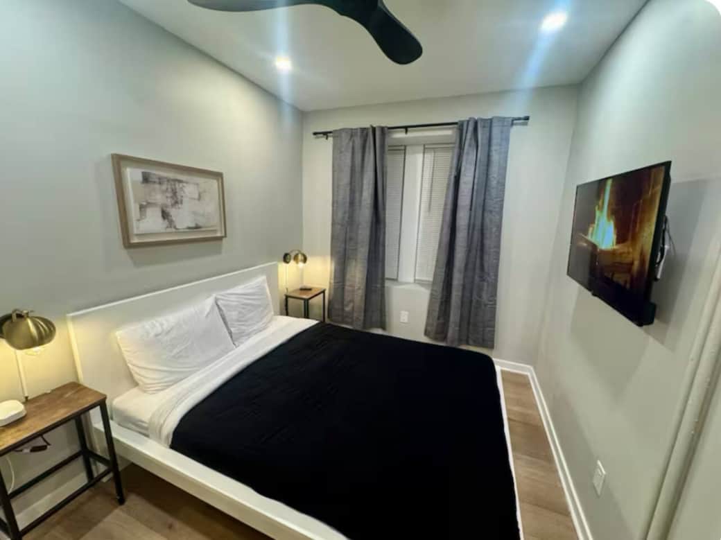This comfortable bedroom includes a queen bed, flat-screen TV, ceiling fan, darkening curtains, a side table, USB charging, lamp, and a spacious closet for all your storage needs.