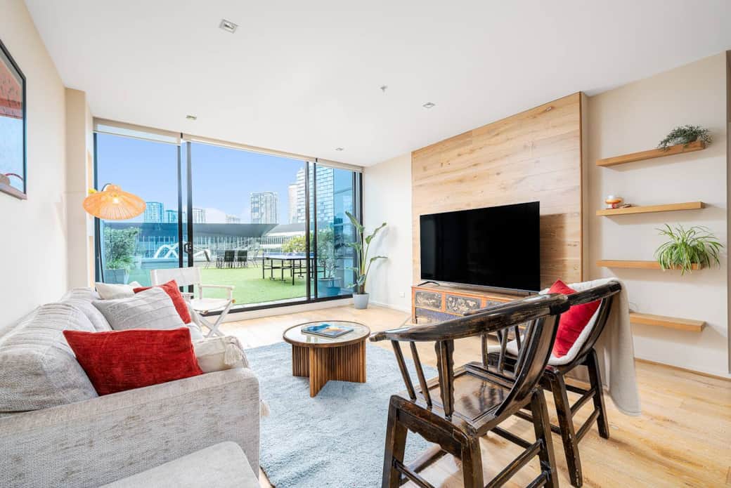 Comfy lounge area, 75 inch TV with complimentary Netflix and views of the Docklands skyscape