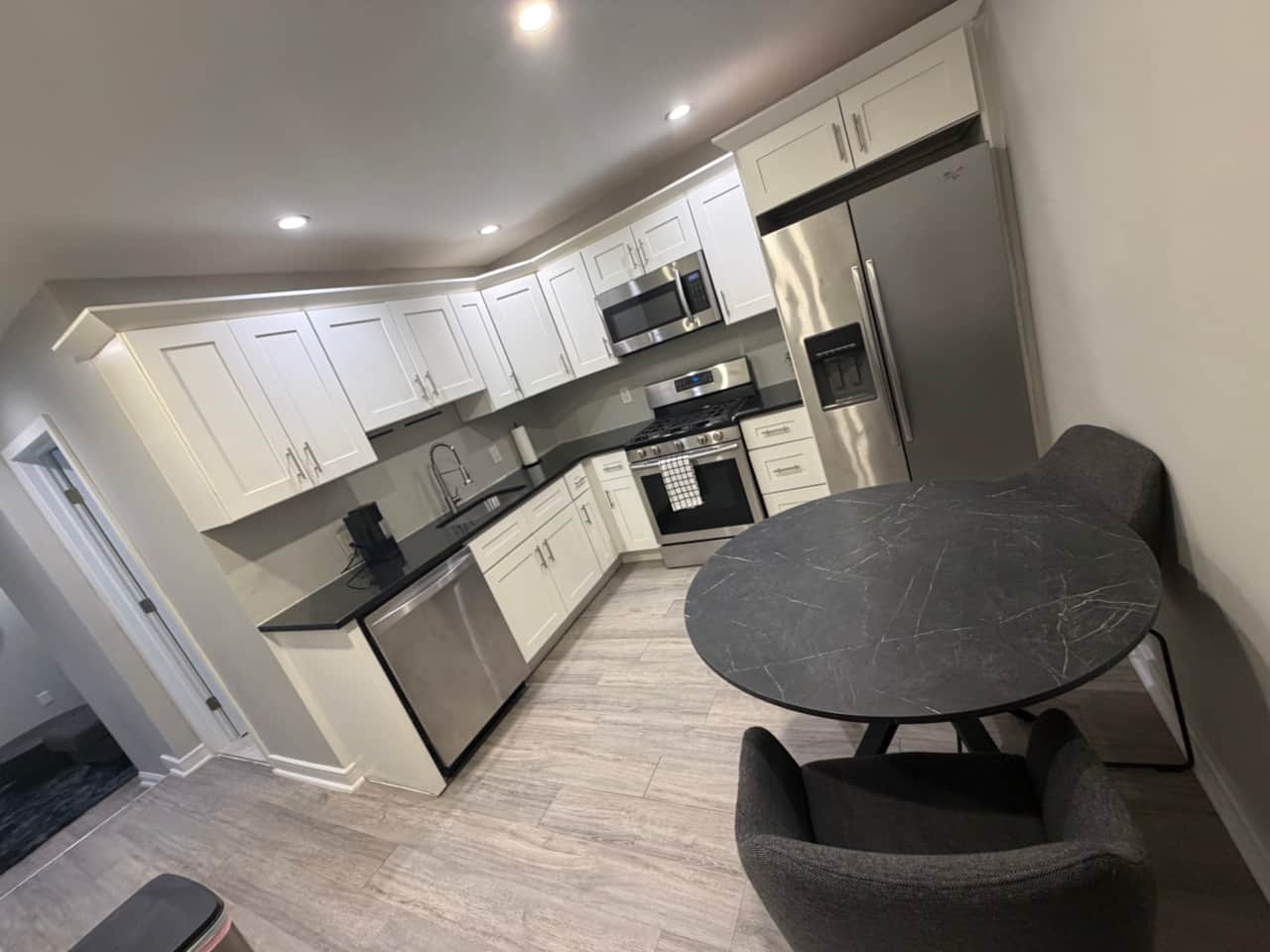  kitchen with all the amenities with breakfast table and two chairs .