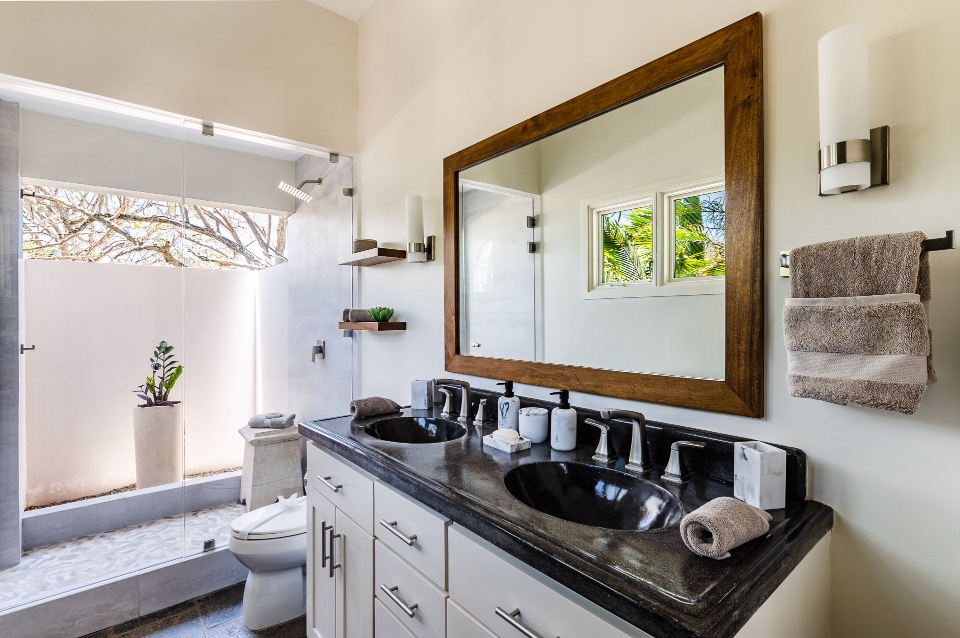 Indoor/outdoor shower and spacious Mr. & Mrs. double sink vanity.