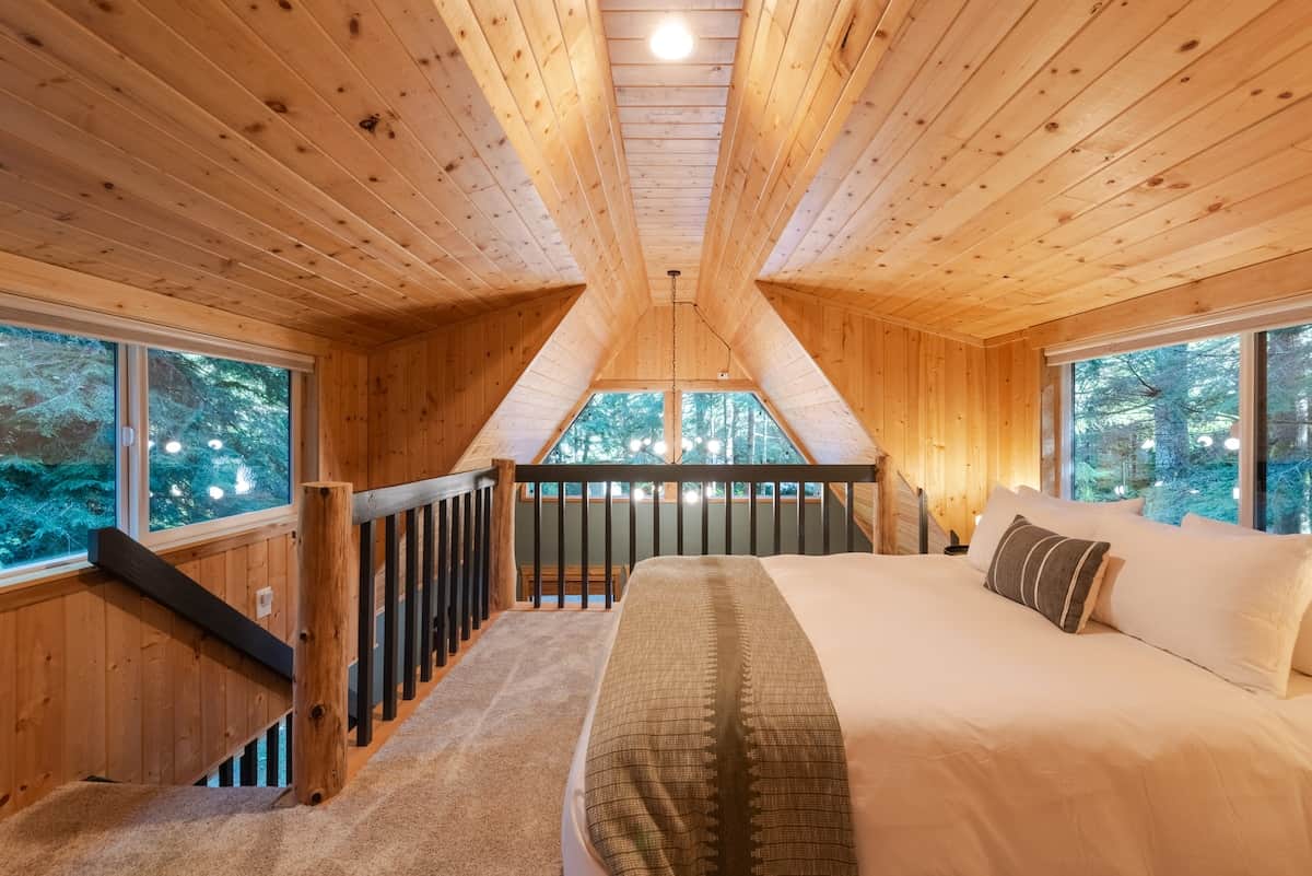 The loft is the sleeping quarters. You'll find two Queen size memory foam beds with plush linens, all while being surrounded by tree-filled windows. 