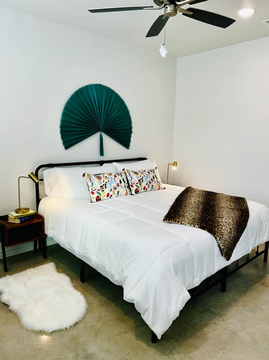 Primary bedroom with king bed, desk workspace, large walk-in closet, and attached bath