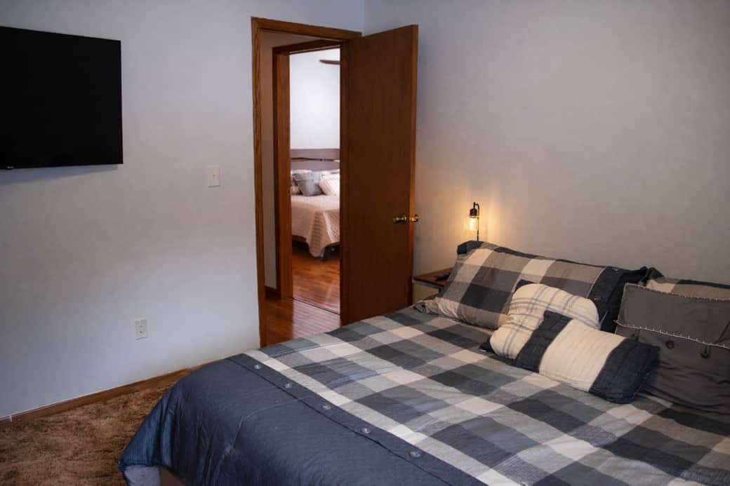 Spacious California king bedroom with 50″ Roku TV and closet storage. Spacious California king bedroom with 50″ Roku TV and closet storage.