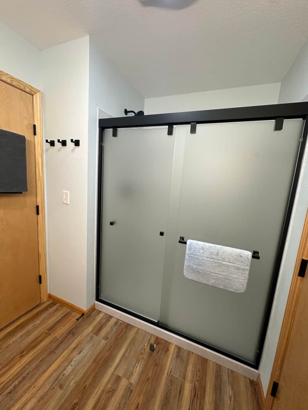 First-floor bathroom with a new walk-in shower, frosted glass doors, and overhead heat light—offering both style and extra comfort after a day outdoors. First-floor bathroom with a new walk-in shower, frosted glass doors, and overhead heat light—offering both style and extra comfort after a day outdoors.
