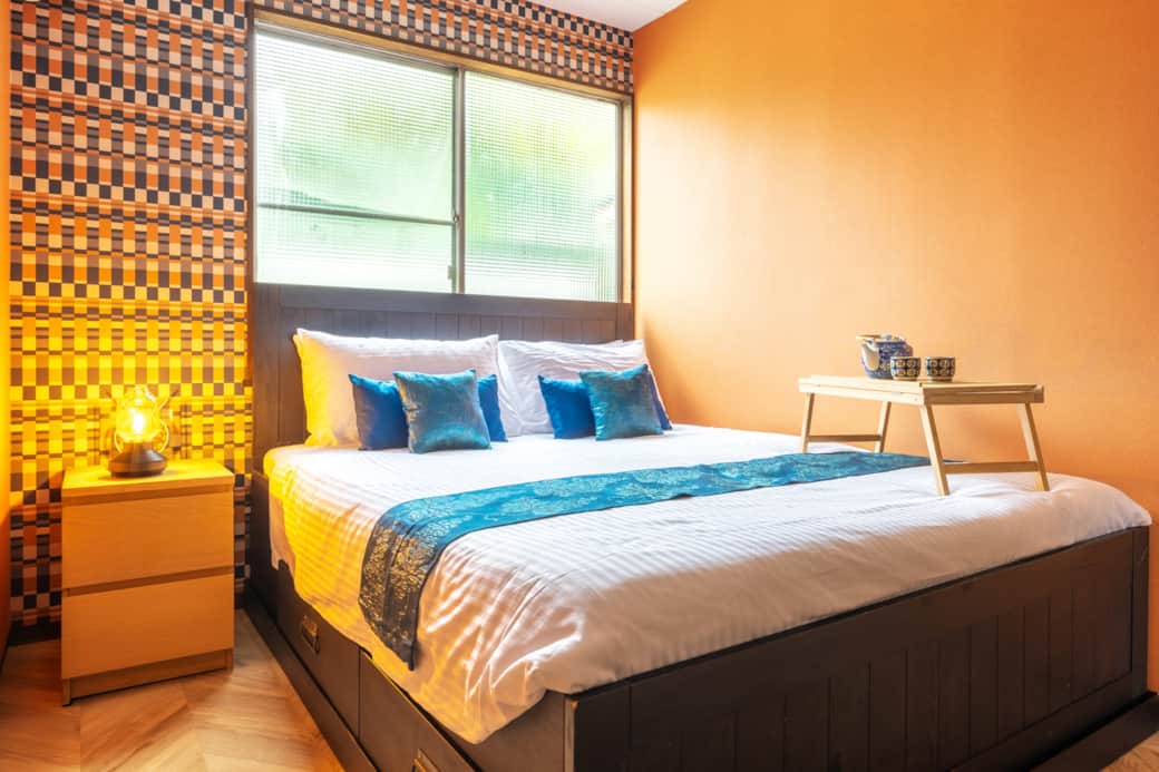 Enjoy comfort and character in this vibrant bedroom with playful retro style