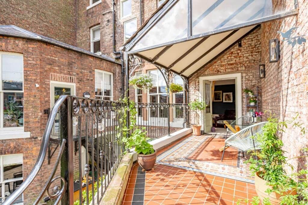 Charming veranda area ideal for morning coffee or evening relaxation overlooking the garden.