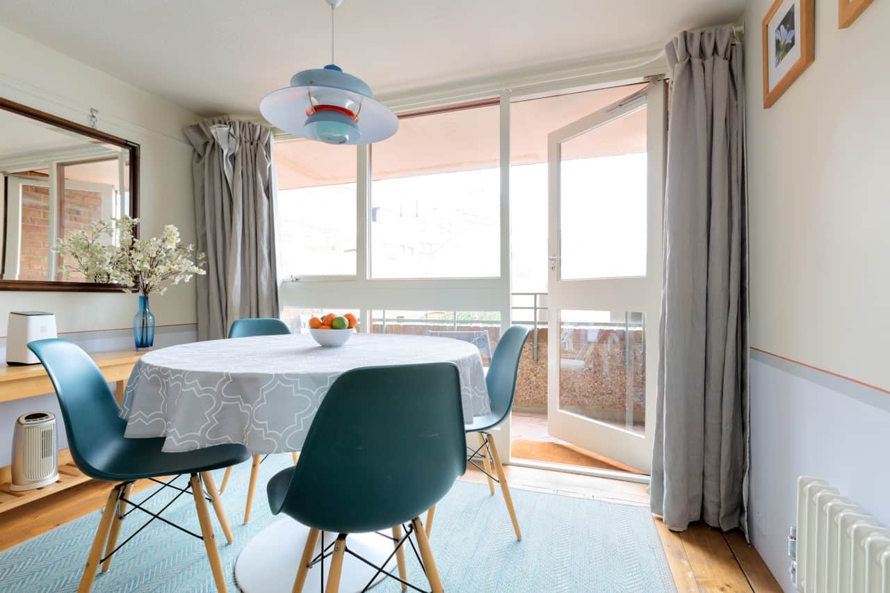 Round table seating four, with doors opening onto the private terrace