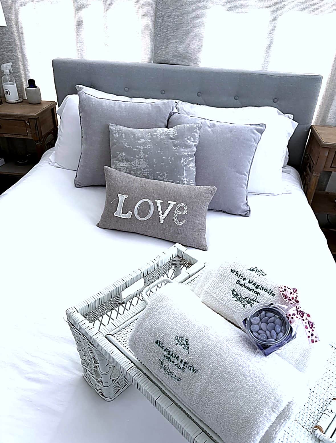 Close-up of luxury linens and pillows on the queen bed at White Magnolia Galveston