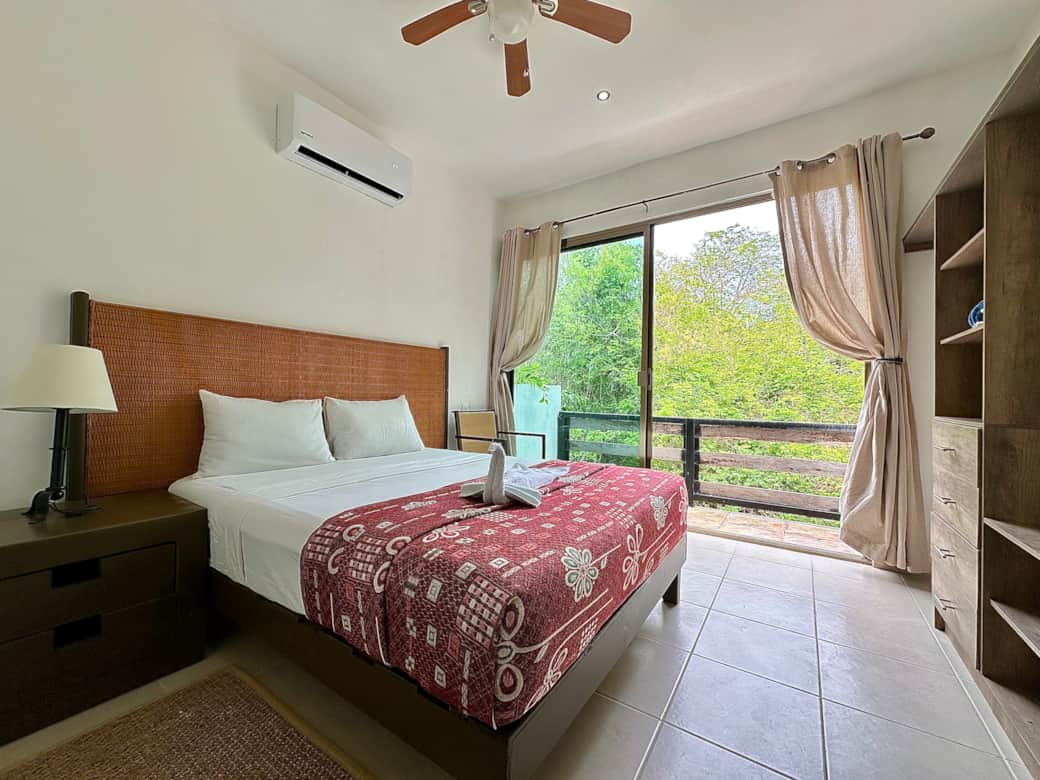 Bedroom with queen size bed and en-suite bathroom and shared balcony