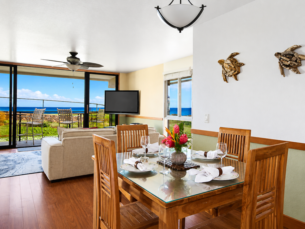 Ocean-view dining area with seating for six guests.