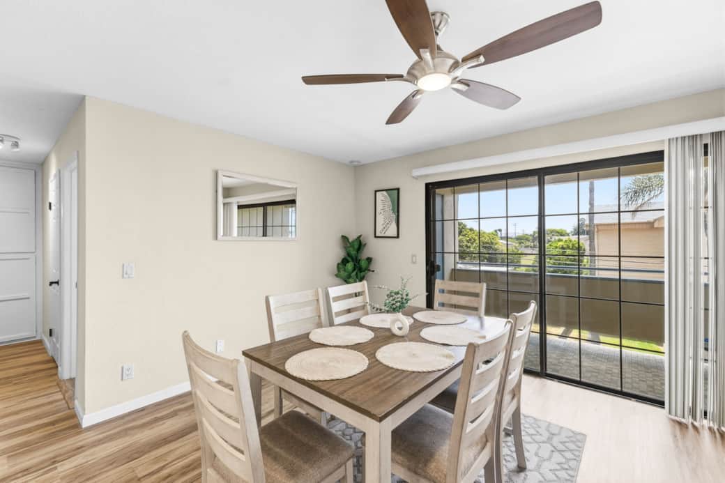 Bright dining area with seating for 6, hardwood floors, and a sliding door leading to balcony Bright dining area with seating for 6, hardwood floors, and a sliding door leading to balcony