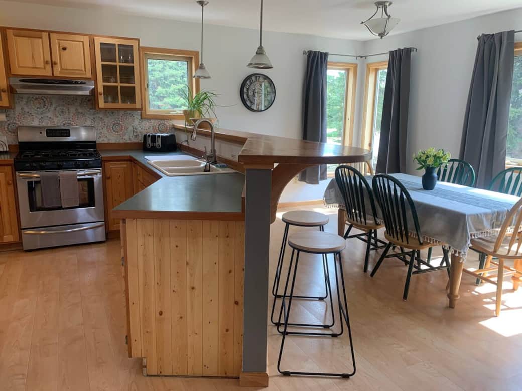 Kitchen with table and barstools for larger parties.