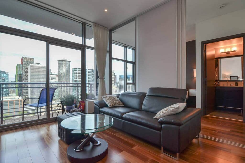 Spacious living room with flatscreen TV and beautiful city views
