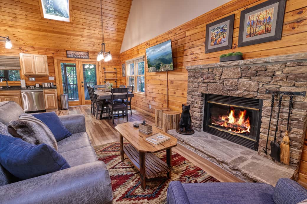 Large open living area with gas fireplace, open kitchen, vaulted ceilings, sky lights & 55" FireTV. 