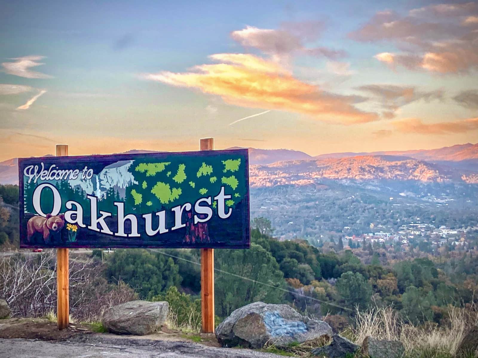 Oakhurst welcome sign overlooking the town at sunset