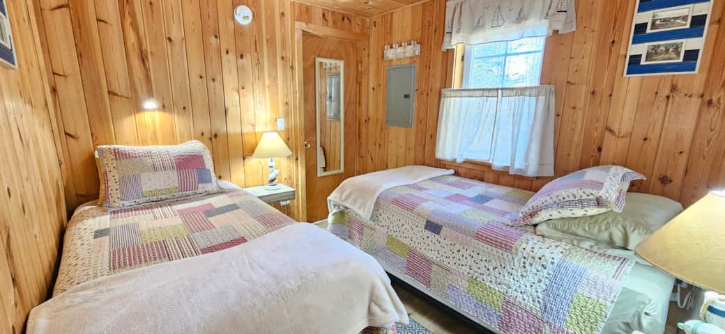 Second bedroom featuring two cozy twin beds, ideal for family or kids