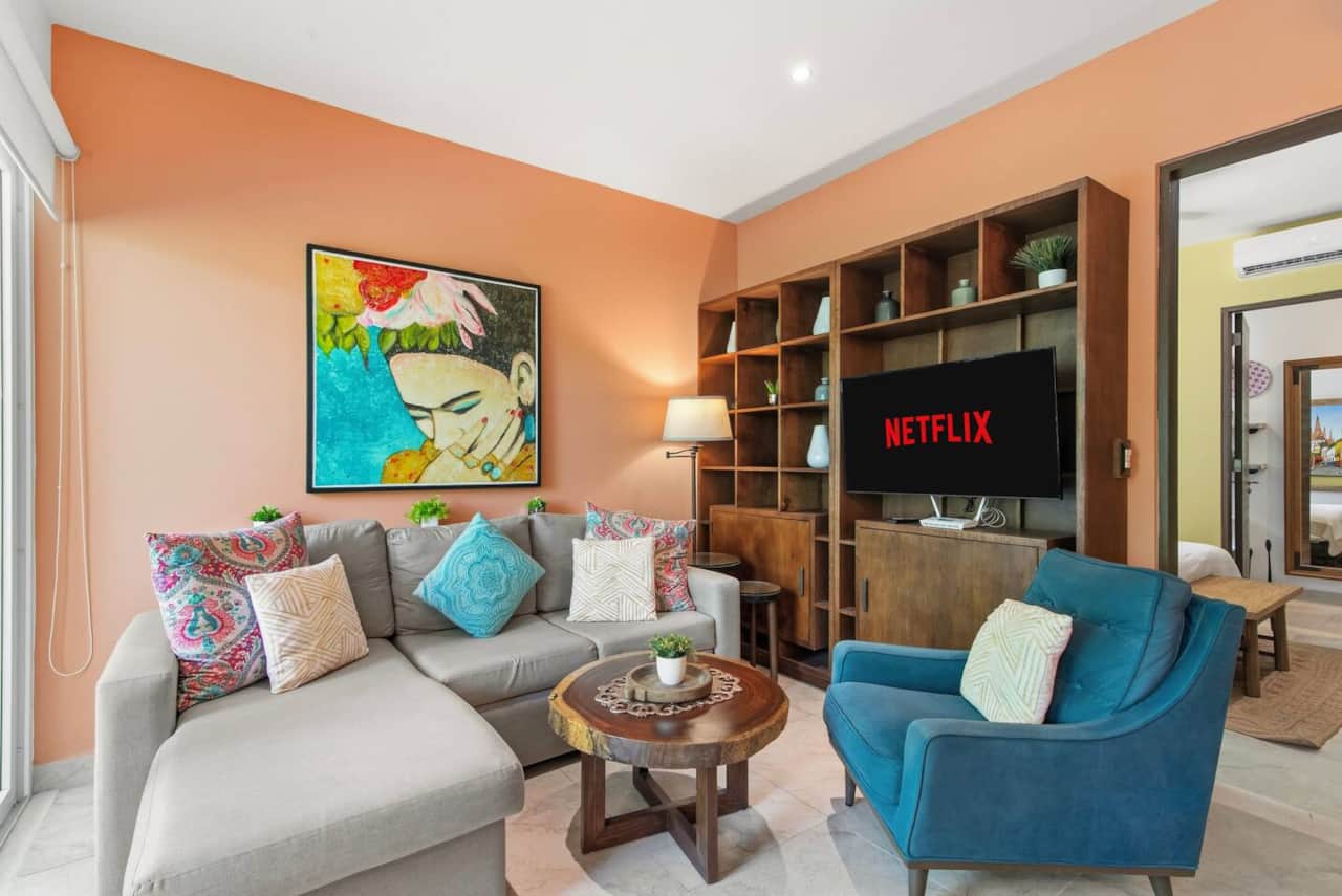 Unwind in this inviting living room, featuring a comfortable sofa that converts into a full-size bed, a cozy armchair, and a Smart TV to enjoy your favorite streaming services.