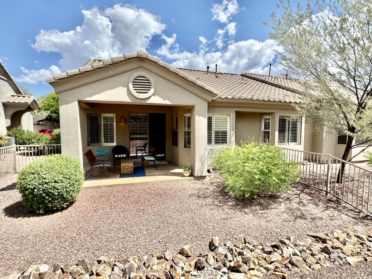 Backyard with gate and fenced in with cozy covered patio 