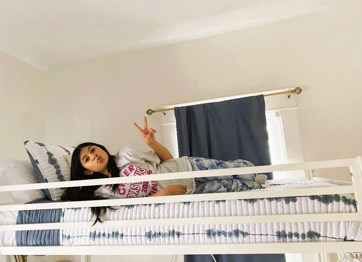 Girl relaxing on bunk bed at White Magnolia Galveston