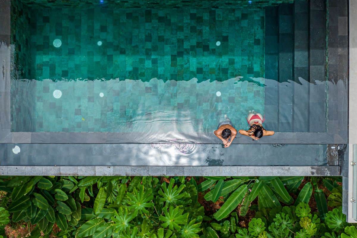 Infinity pool at Villa Sueño with a couple relaxing in the pool.