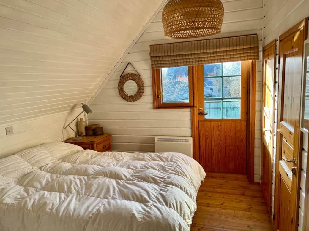 Master bedroom, king size bed, access to balcony, en-suite, large cupboard, storage heater, TV not visible