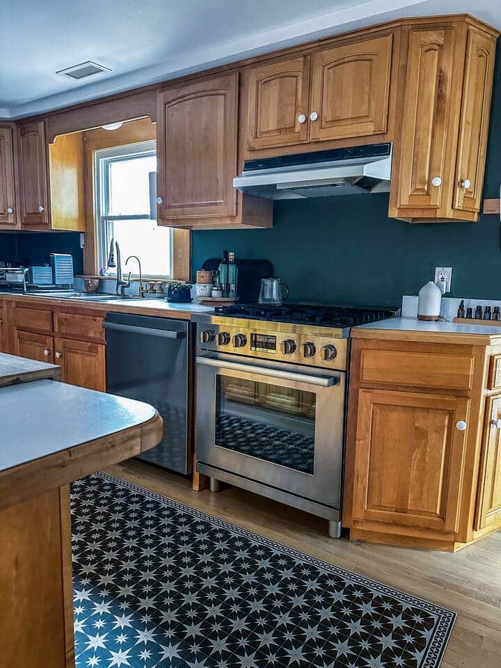 Large open kitchen with commercial gas stove, dishwasher and breakfast island. 