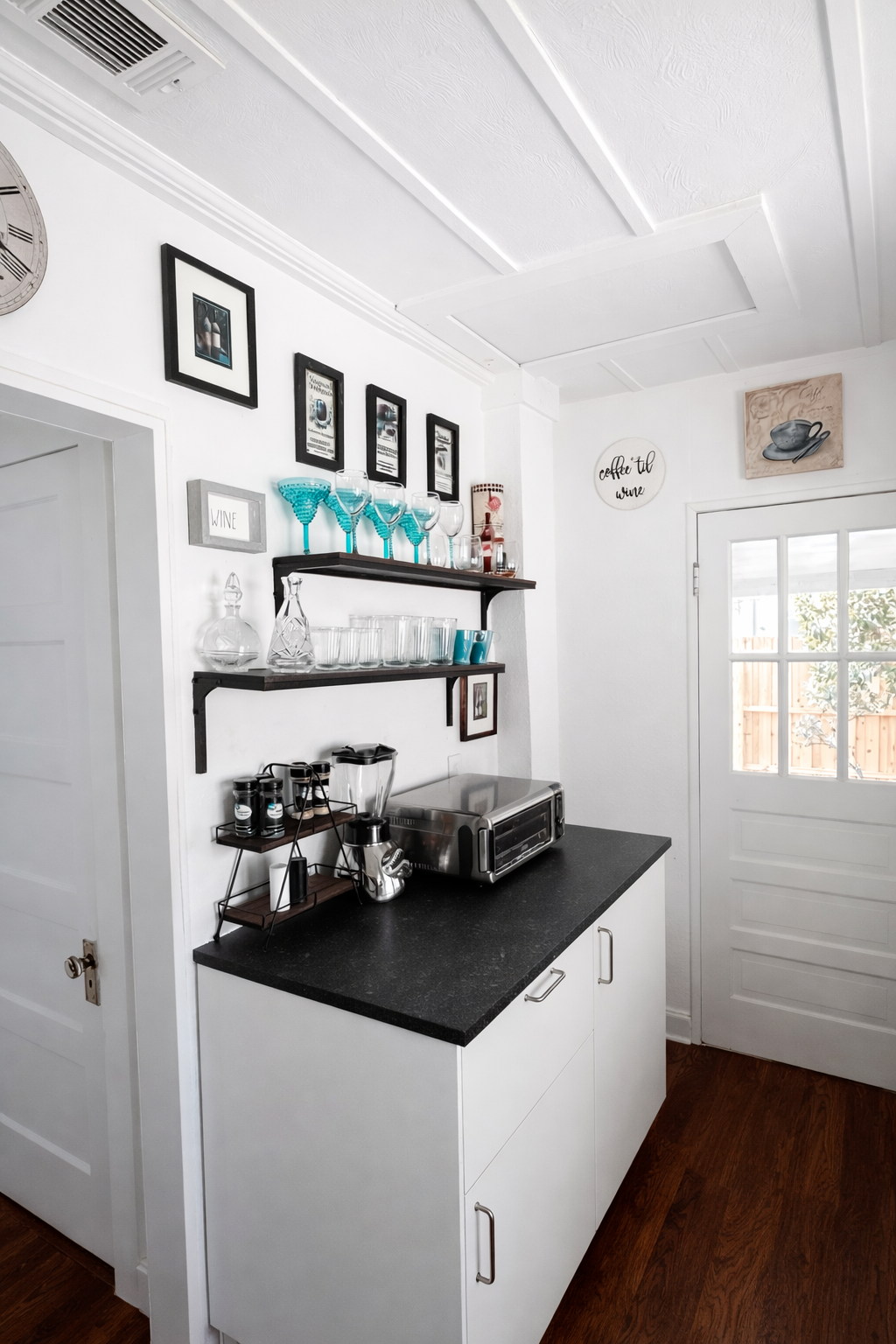Bright kitchen nook with wine glasses ready and easy access to the patio, 
