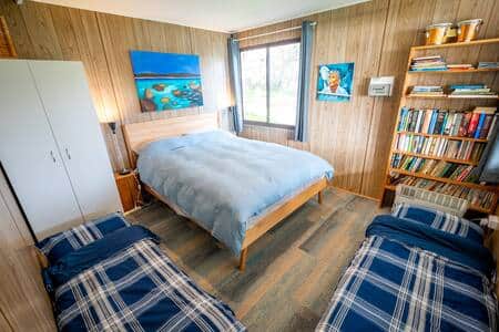 Second bedroom with queen bed and option for two single beds on the floor.