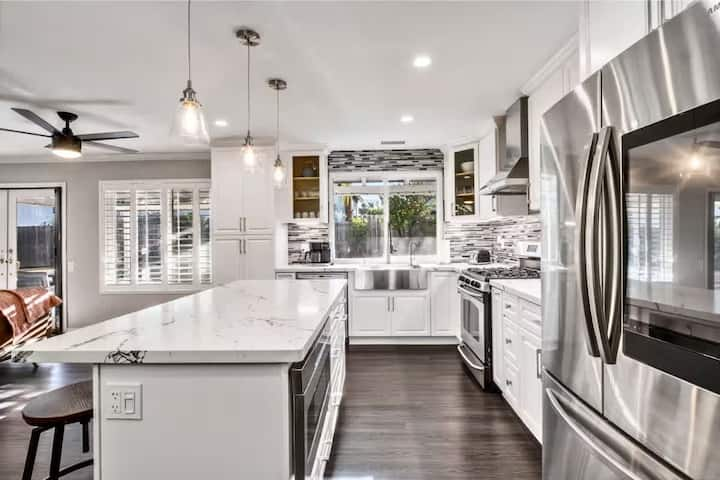 Modern kitchen with large island, stainless steel appliances, and ample counter space.