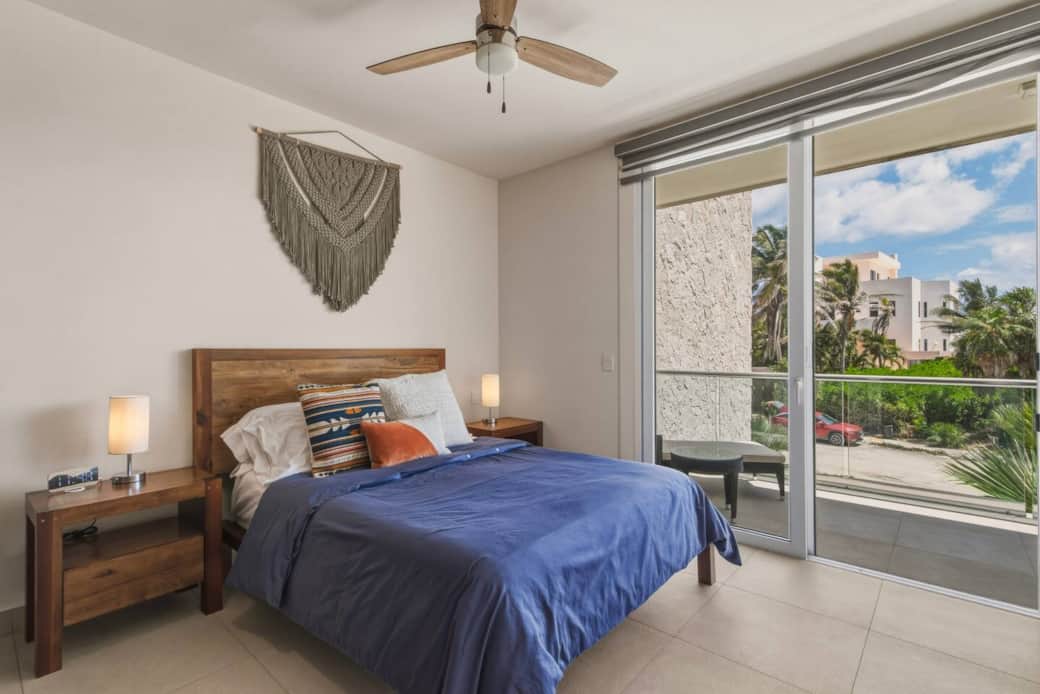 Cozy bedroom with a comfortable queen bed and direct access to your private balcony—perfect for enjoying the view and sea breeze. Includes A/C, ceiling fan, room-darkening shades, and bedside lamps with easy-access outlets for a restful stay. Cozy bedroom with a comfortable queen bed and direct access to your private balcony—perfect for enjoying the view and sea breeze. Includes A/C, ceiling fan, room-darkening shades, and bedside lamps with easy-access outlets for a restful stay.