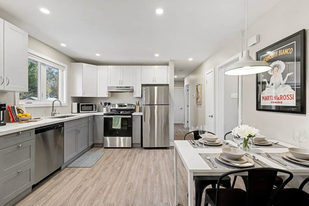 This fully stocked kitchen features sleek stainless steel appliances, stylish two-toned cabinets, and quartz countertops. Everything you need for comfortable midterm living and effortless home-cooked meals. 