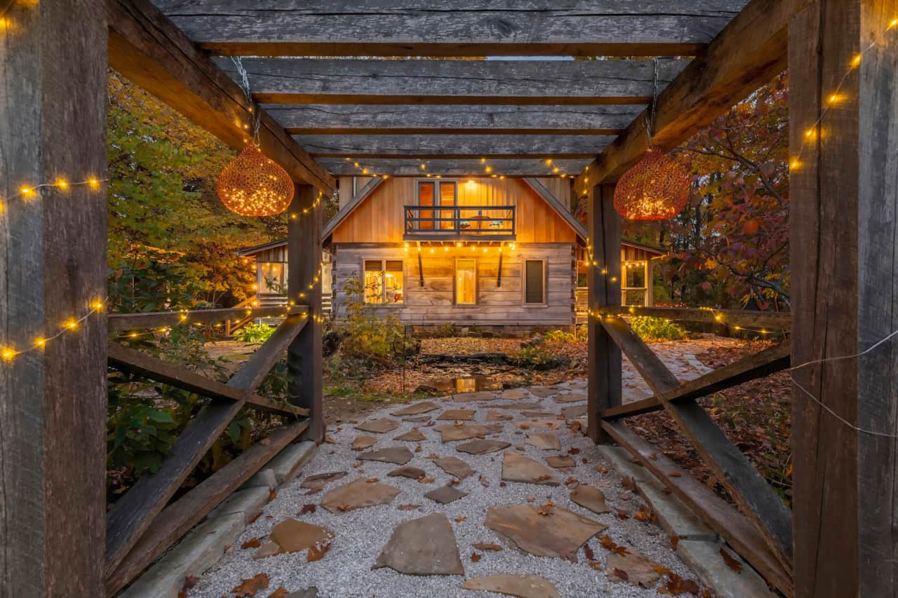 The Magical Entrance to Cabin Porch Paradise is stunning at twilight.  All light up with fairy lights, and cafe lights.  Meandor the new flagstone path to your vacation paradise in nature.
