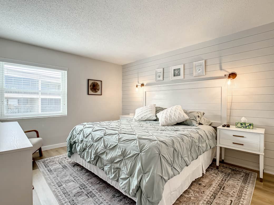 Primary bedroom with king-size bed and calming decor at Gulf Coast 107