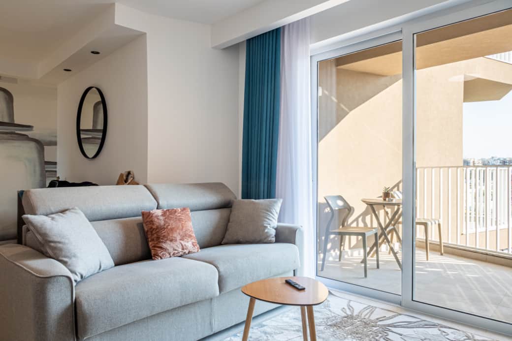 Seating area with sofa bed and balcony access