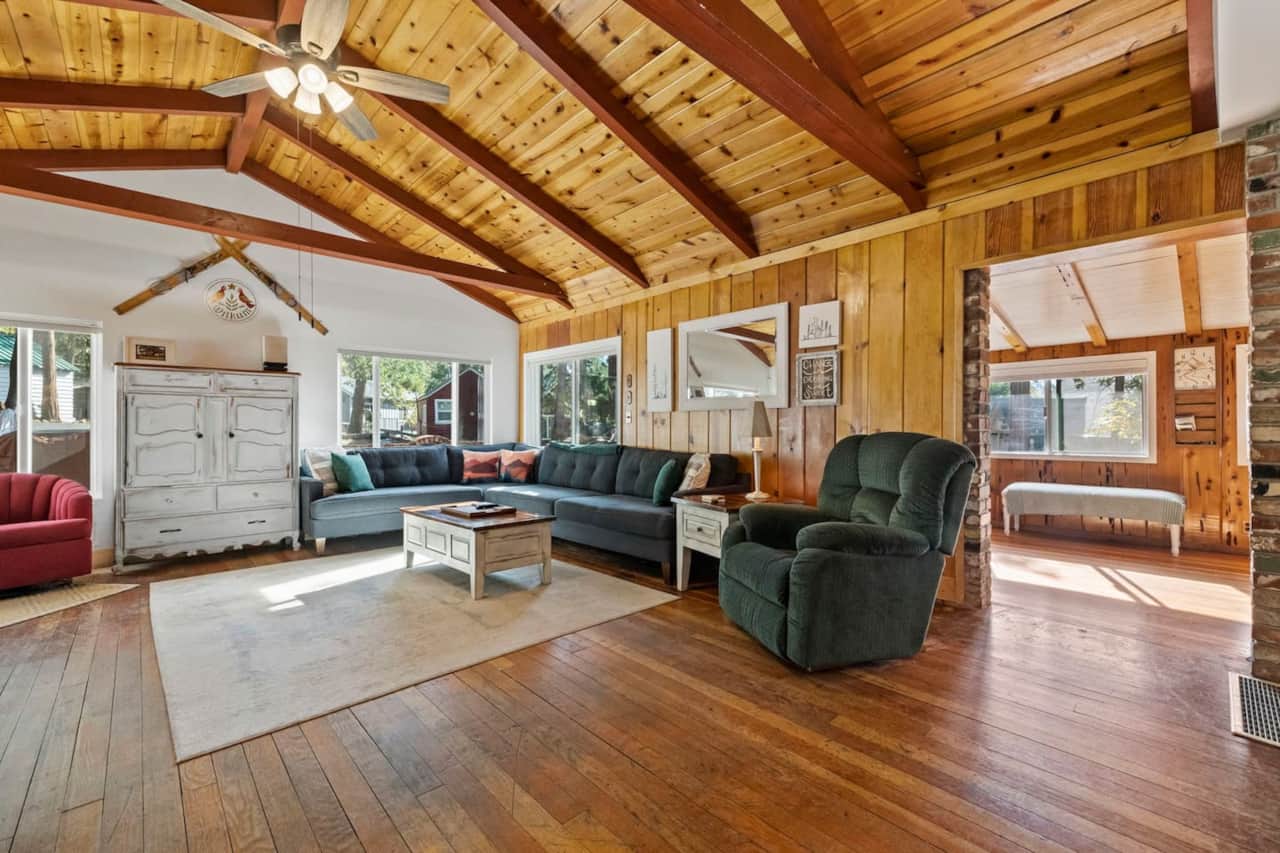 Unwind in style beneath the expansive open beam ceiling and knotty pine walls of this vast living room, offering an abundance of seating, where relaxation meets rustic elegance in a setting that's both spacious and inviting. ✨️ #RusticLuxury 