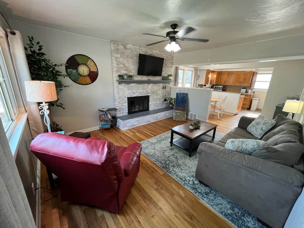 Cozy living room with fireplace and open layout to kitchen for easy gathering. Cozy living room with fireplace and open layout to kitchen for easy gathering.