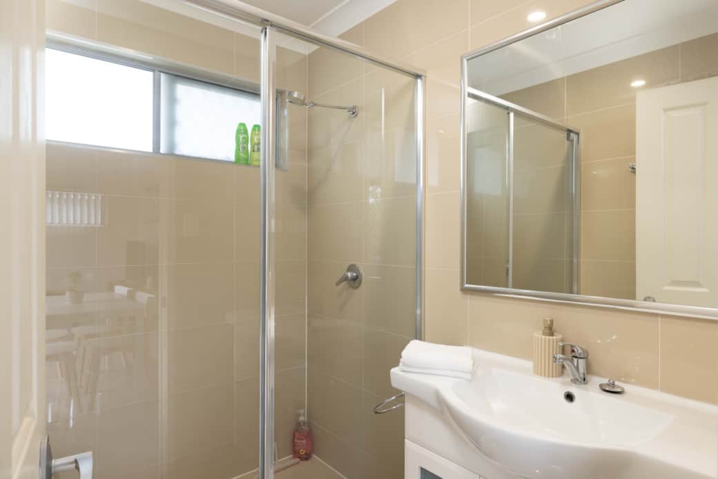 Bathroom: Stylish bathroom with walk-in shower, vanity, and clean finishes