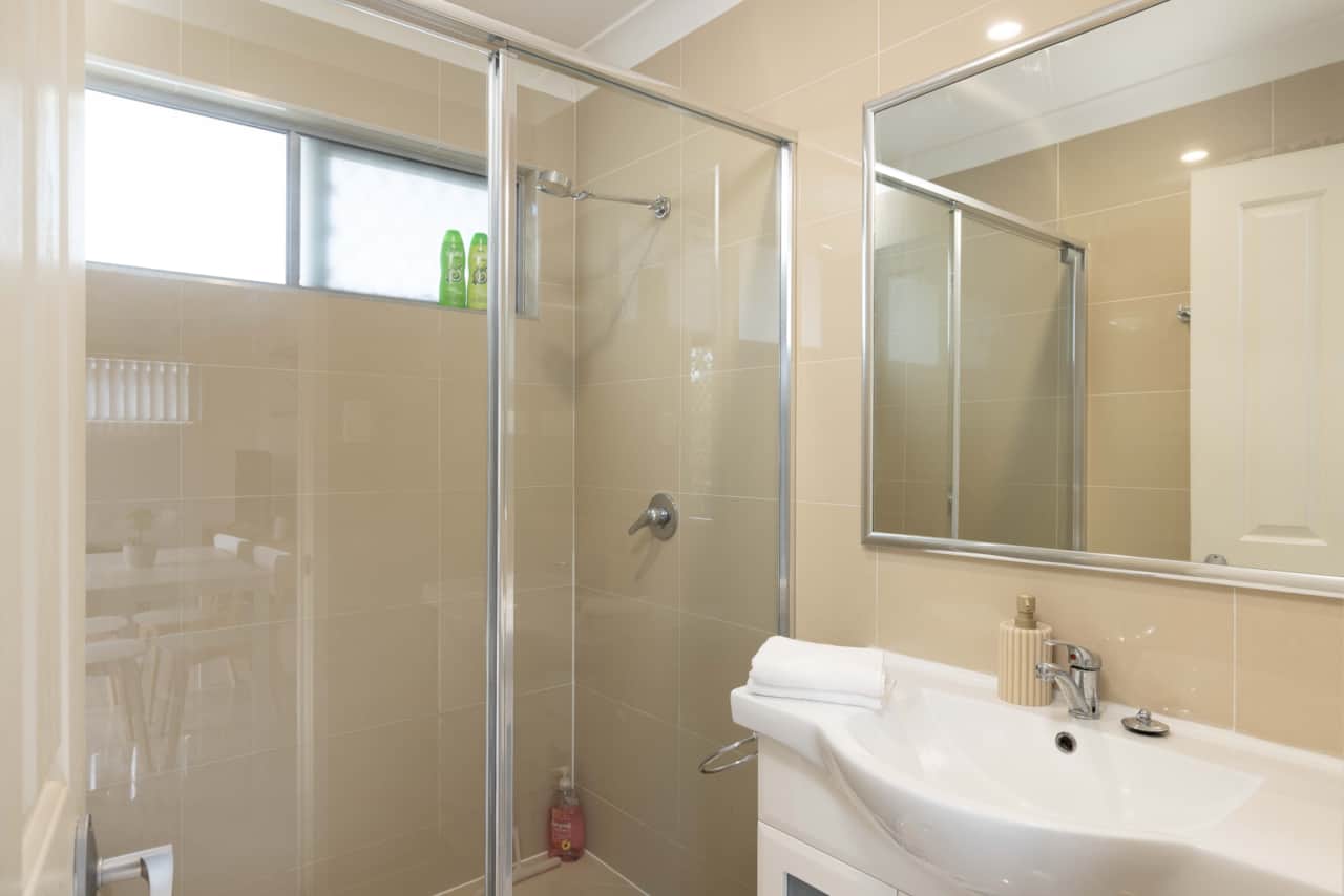 Bathroom: Stylish bathroom with walk-in shower, vanity, and clean finishes