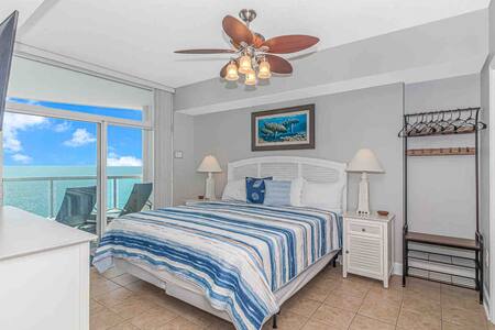 Spacious master bedroom w/ stunning ocean view, balcony, ensuite bathroom and flat screen tv.