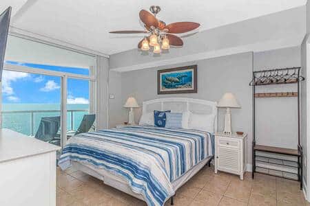 Spacious master bedroom w/ stunning ocean view, balcony, ensuite bathroom and flat screen tv.