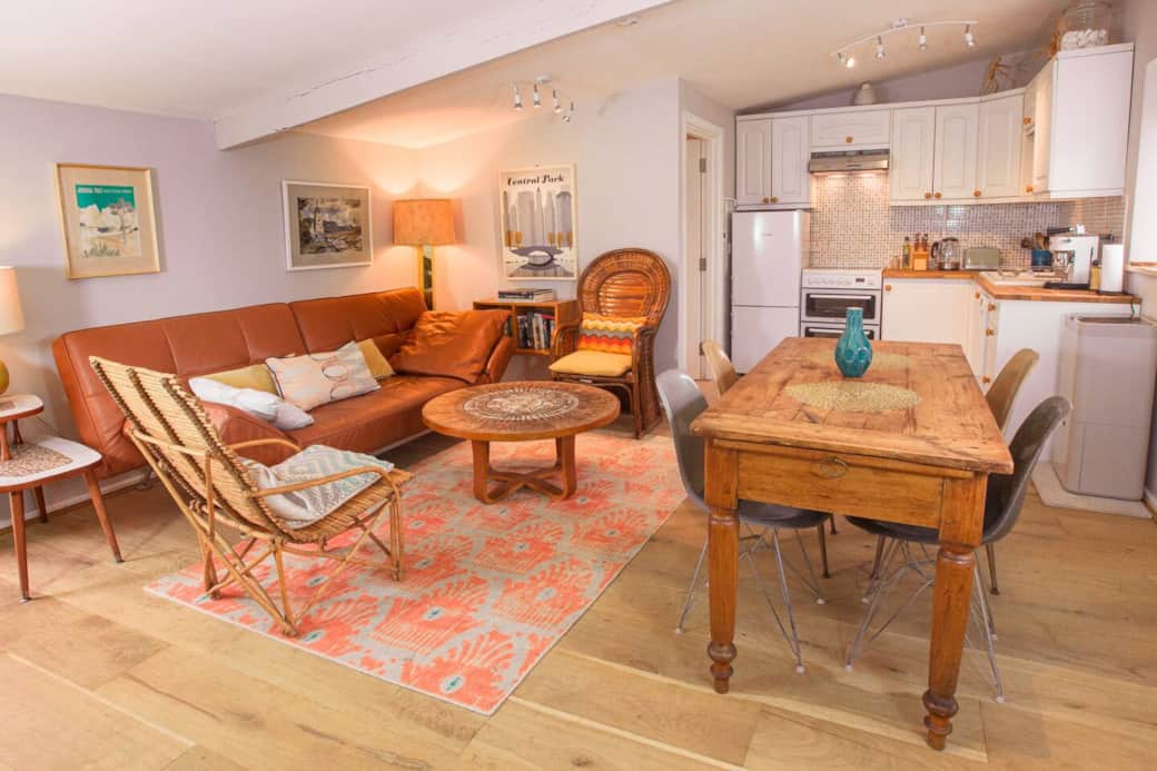 Open plan kitchen/living/dining area with shower/toilet back left hand corner.